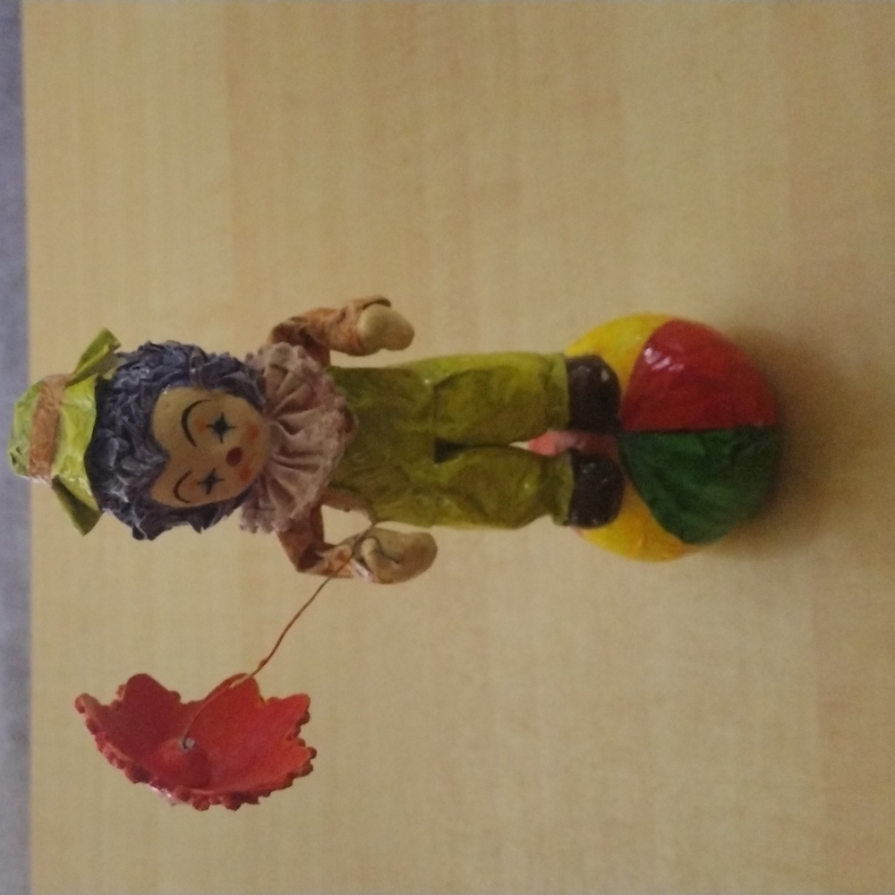 Vintage paper mache clown with umbrella on ball.